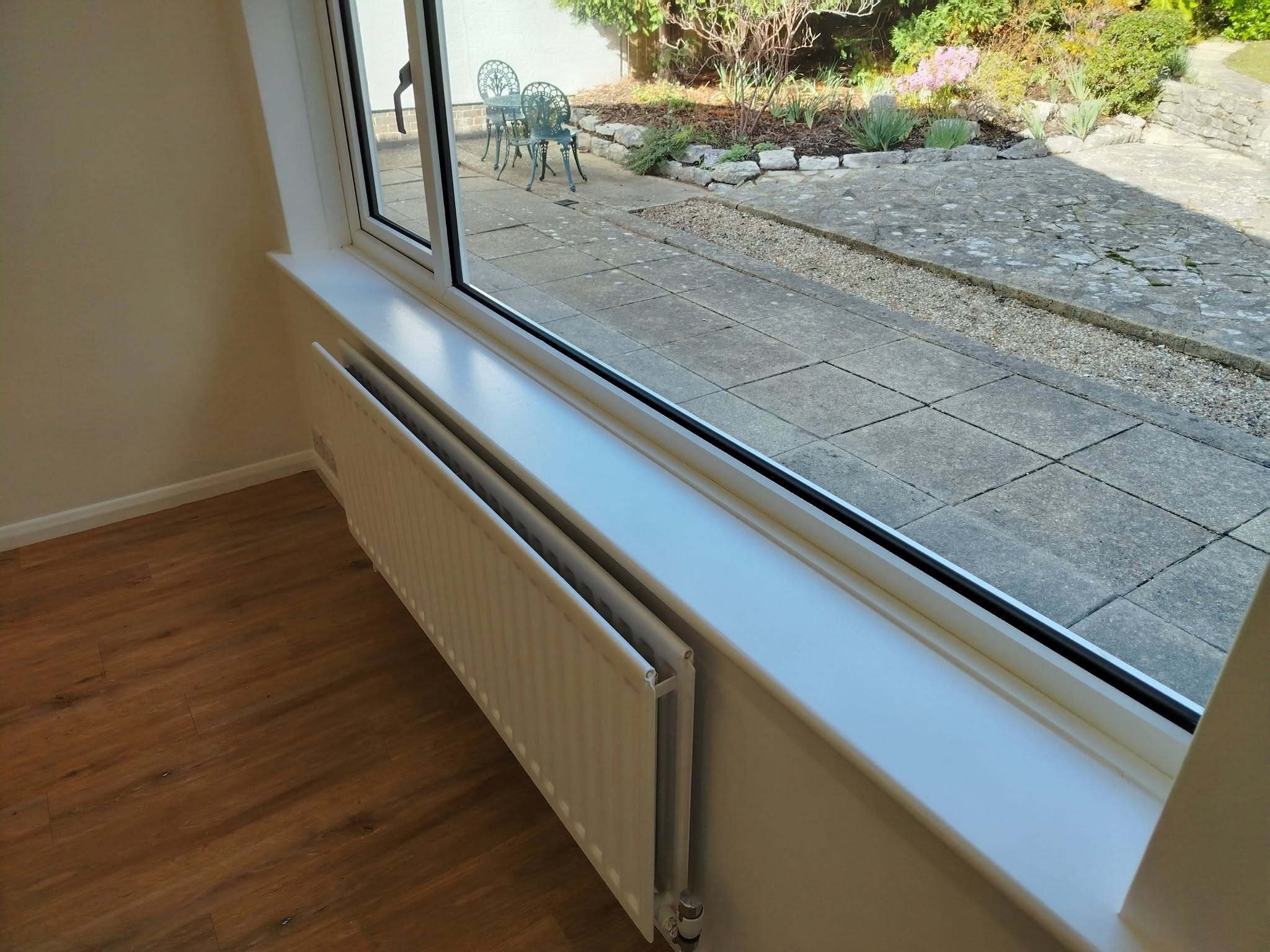 The same window wall after: finished in white
