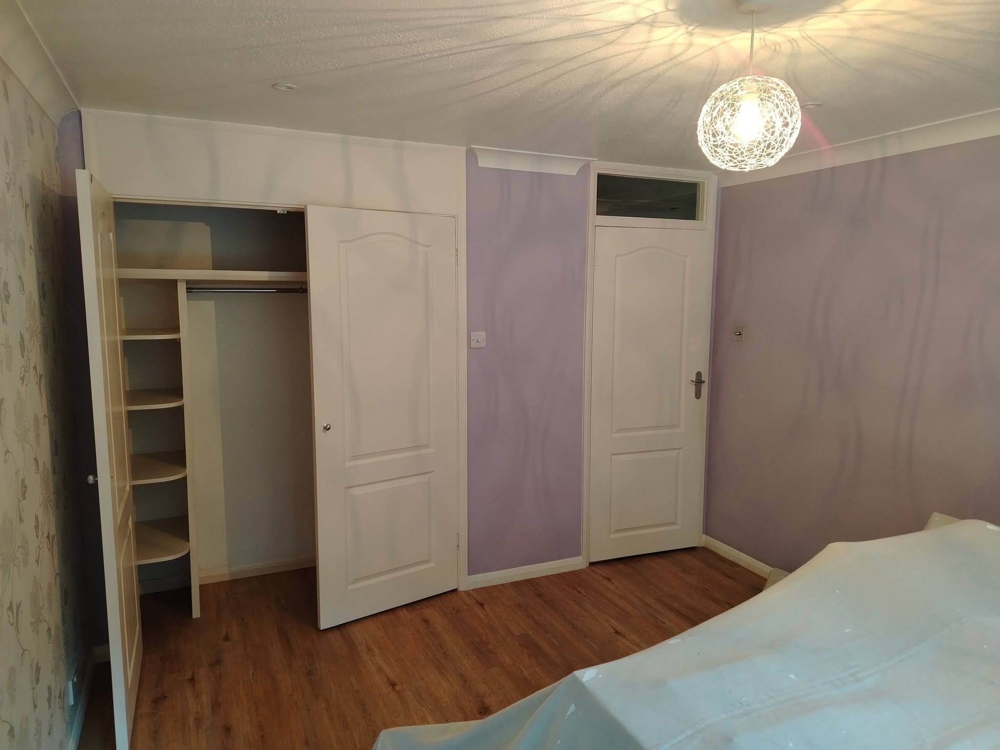 Bedroom wardrobe wall before: lilac walls