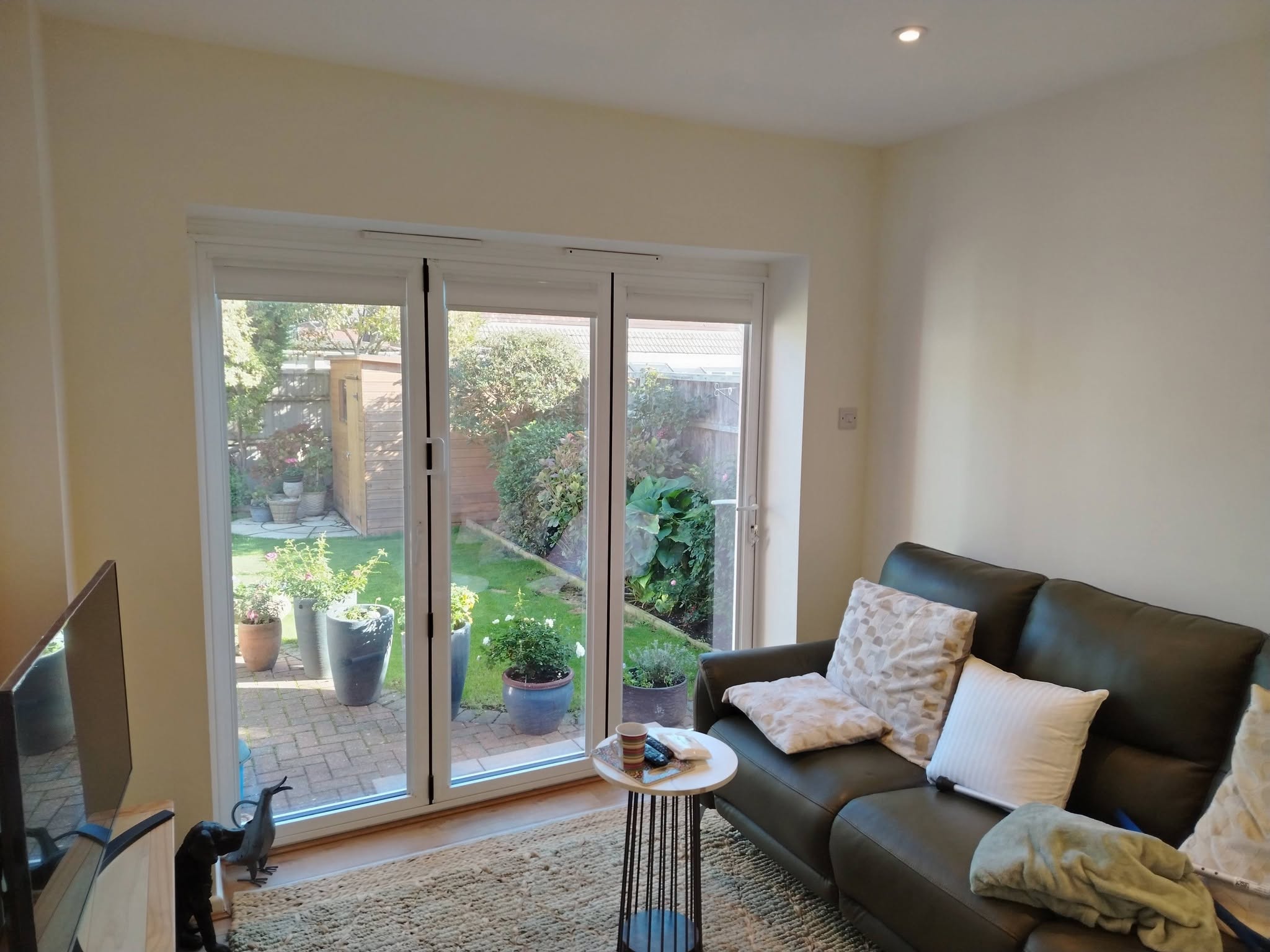 Bright lounge in cream with French doors to the garden