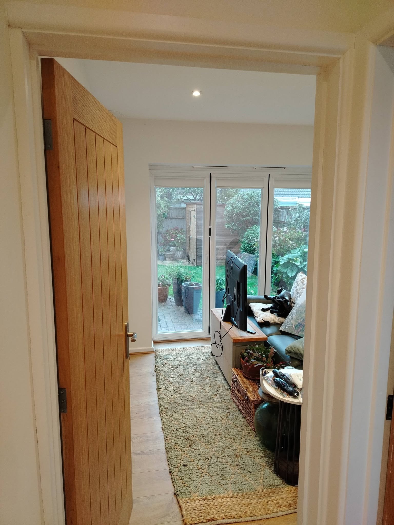 Oak door opening onto a finished lounge