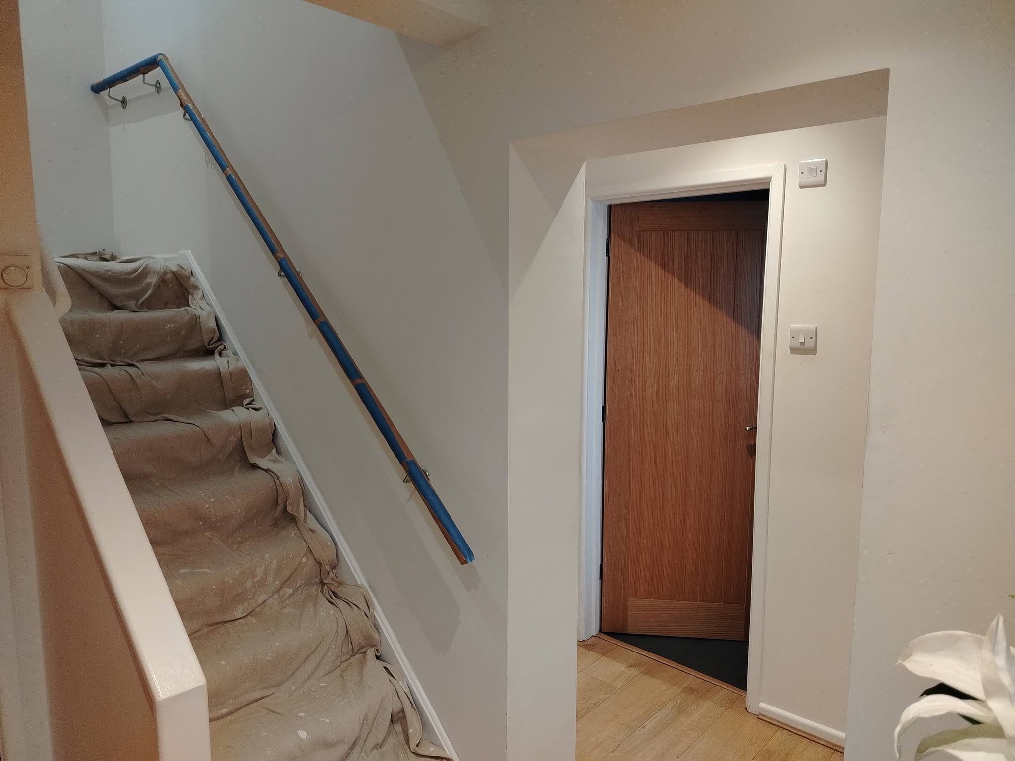 Stairs and doorways protected with dust sheets during a job
