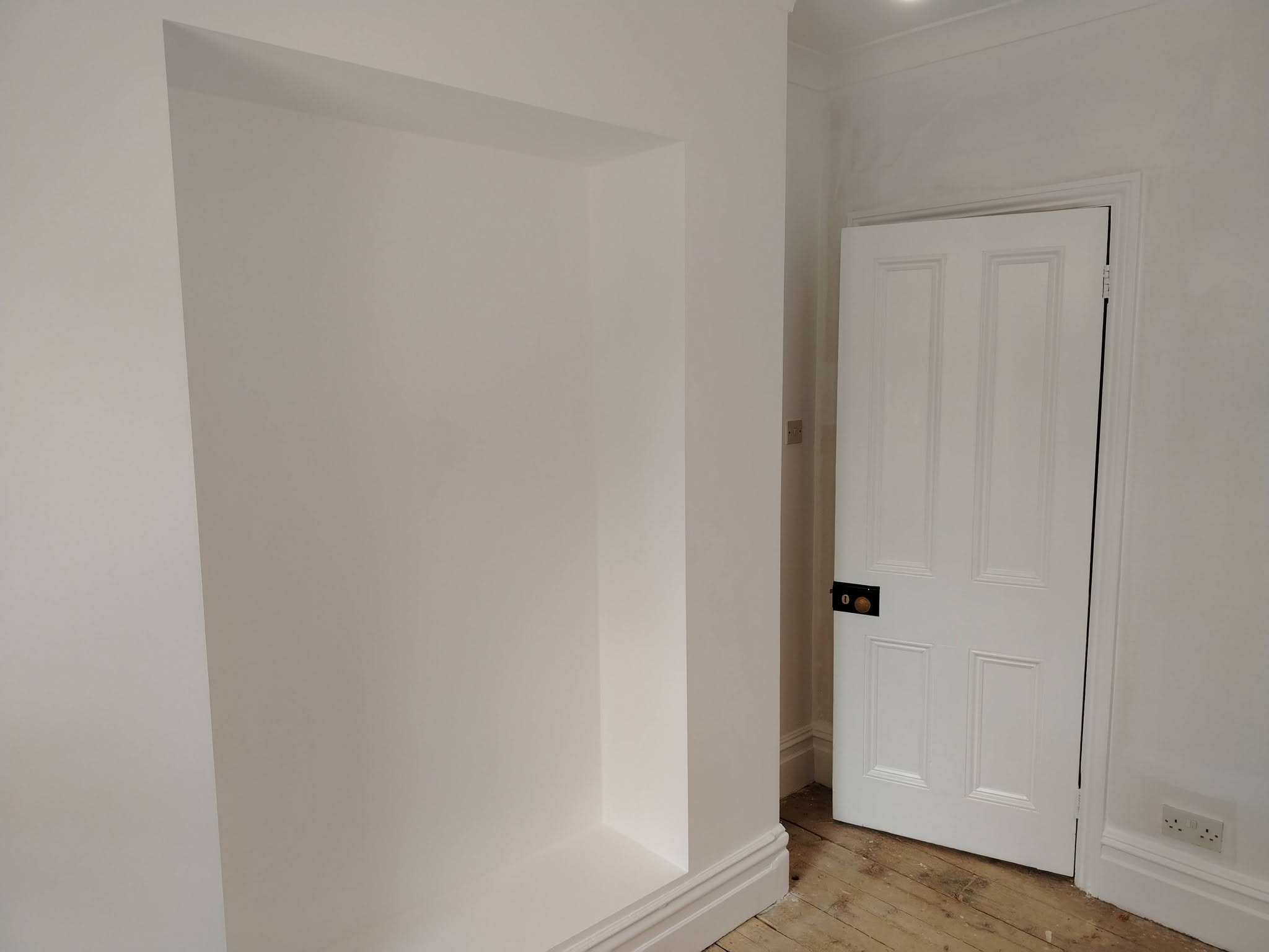 White alcove and panelled door, freshly painted