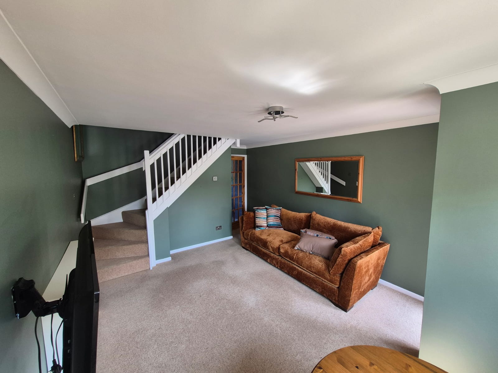 Green lounge with white stair spindles